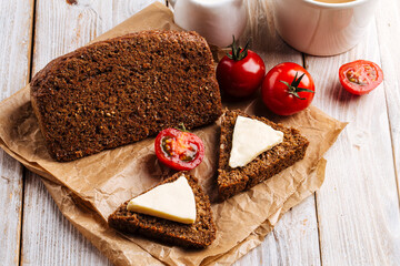 Flourless diet grain bread with cheese and coffee on the wooden table