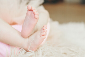 Obraz na płótnie Canvas Baby's feet, fingers close up. newborn baby legs, massage concept of childhood, health care, IVF, love