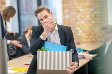 Unhappy pensive man touching face with hand