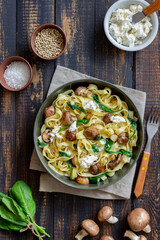 Linguine pasta with mushrooms, white cheese, spinach and garlic. Healthy eating. Vegetarian food. Diet.
