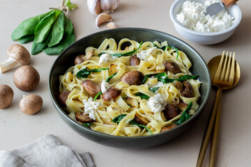 Linguine pasta with mushrooms, white cheese, spinach and garlic. Healthy eating. Vegetarian food. Diet.