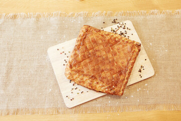 Pie on a chopping board. The food is ready to eat. Puff Pastry pastry