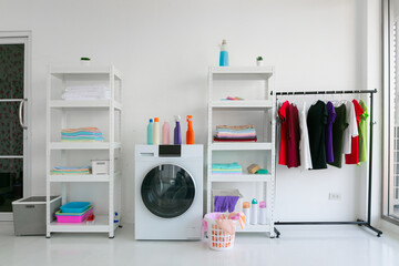 Laundry room interior with washing machine against white wall.