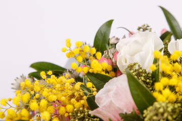 Floral arrangement with mimosa and animons on gray background 