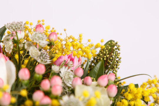 Floral arrangement with mimosa and animons on gray background 