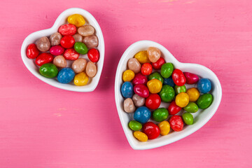 Multicolored candies in a plate in the shape of a heart