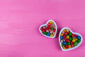 Multicolored candies in a plate in the shape of a heart