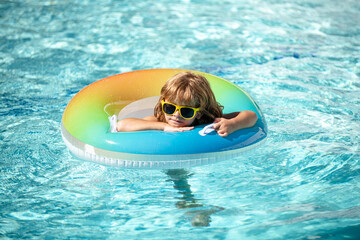 Child summer vacation. Summertime kids weekend. Boy in swiming pool.