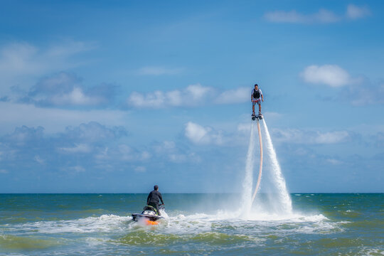 Professional pro fly board rider in tropical sea, water sports concept background. Summer vacation fun outdoor sport.