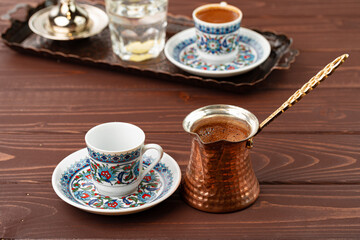 Cup of coffee in oriental style on metal tray