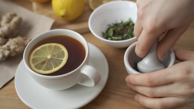 Cup of healthy tea with different kind of dryed herbs