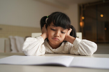 Serious student reading the book for knowledge at home during night period.