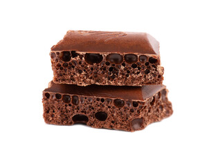 Porous chocolate pieces isolated on white background. Black aerated chocolate.