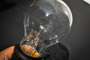 close up of light bulb on black background
