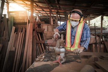 Strong man carpenter using table saw Industrial work concept