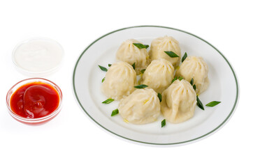 Boiled hot khinkali with meat, spices and ketchup.