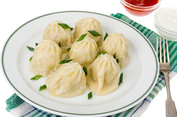 Boiled hot khinkali with meat, spices and ketchup.
