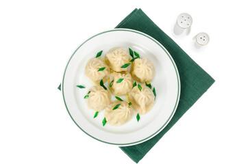 White plate with boiled khinkali, green onions.
