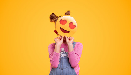 Kid hiding face behind emoticon