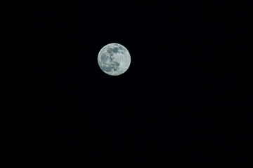 Closeup of full moon. Shining Moon closeup in black background. Soft focus