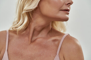 Neckline and chin of middle aged caucasian woman