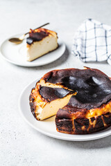 Basque burnt cheesecake on white plate. Spanish cuisine concept.