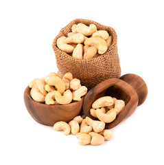 Cashew nuts in bag and wooden bowl, isolated on white background. Roasted cashew nuts.
