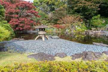 Fototapeta na wymiar Autumn leaves scenery with Japanese garden in Japan