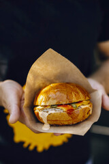 mens hands holding a burger