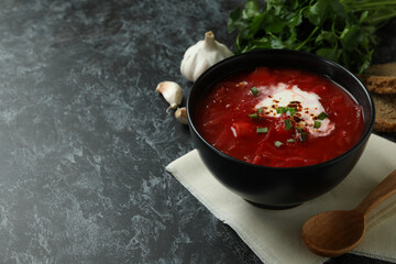 Concept of tasty eating with borscht on black smokey background