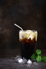 Iced coffee or frappe with mint  in a tall glass.