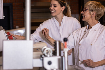 Bakers preparing dough for baking bread in modern manufacturing.