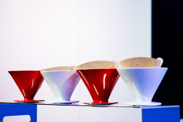 red and white coffee filters in a row