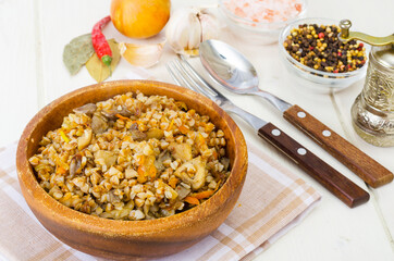 Boiled buckwheat porridge with stewed mushrooms and vegetables.
