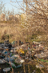 Naklejka na ściany i meble Environmental pollution. Garbage dump in the field. Illegal garbage dump