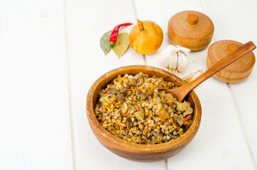 Boiled buckwheat porridge with stewed mushrooms and vegetables.