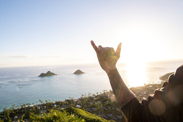 The famous Shaka over a sunset at a popular Hawaii Hike. 
