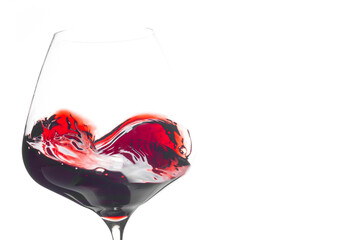 Heart shaped wine swirling in balloon glass