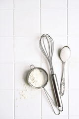 Culinary background with props and  ingredients for baking : flour, egg and sugar. Top view with copy space.