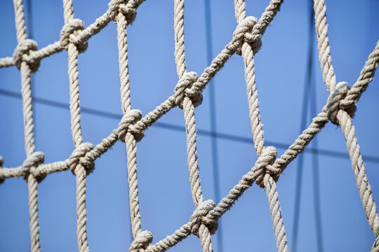 a net of thin ropes on the playground, close-up.