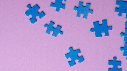 scattered puzzle pieces on colored background
