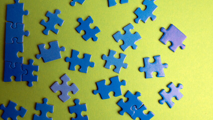 scattered puzzle pieces on colored background