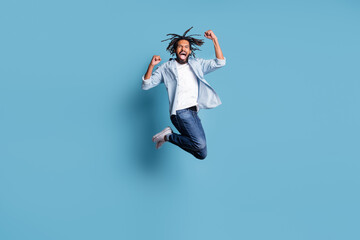 Full length photo of astonished dark skin person jumping fists up open mouth celebrate isolated on...
