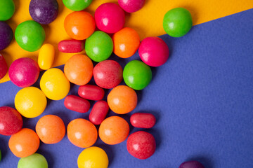 colorful little candies on a colored background