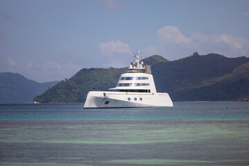 Fototapeta na wymiar Expensive stealth luxury super yacht moored off Curieuse island in the Seychelles