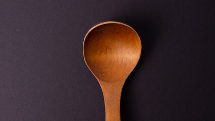 wooden spoon on black background