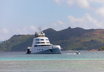 Fototapeta na wymiar Expensive stealth luxury super yacht moored off Curieuse island in the Seychelles