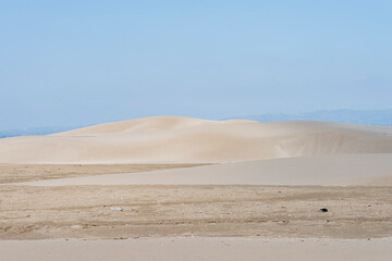 Beautiful sand dunes at dusk against blue sky