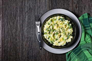 Irish colcannon on a black plate, copy space