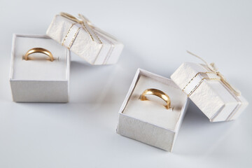 Box with wedding rings, white background.